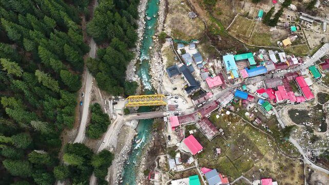 Bird&rsquo;s eye view of Harsil Valley in Uttarkashi, showiBird&rsquo;s eye view of Harsil Valley in Uttarkashi, showing houses, flowing river, and dense pine forest captured from drone.