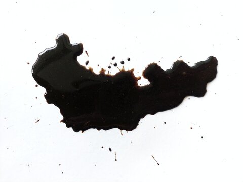 Spilled coffee splash stain isolated on white background. Coffee drink beverage splashing dirty stain texture.