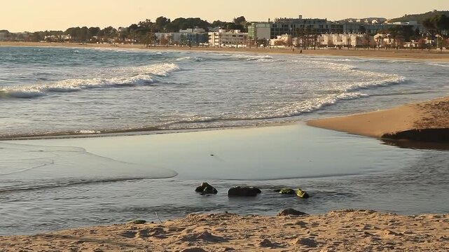 Waves breaking on the beach of Comarruga, Tarragona