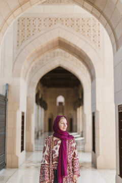 White woman wearing headscarf at Islamic mosque in Middle East.