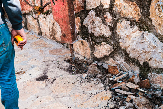hydraulic rock breaker crushing stones at construction site