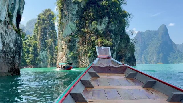 Bow of the boat moving through the beautiful limestone cliffs on the lake in Kao Sok National Park in Thailand