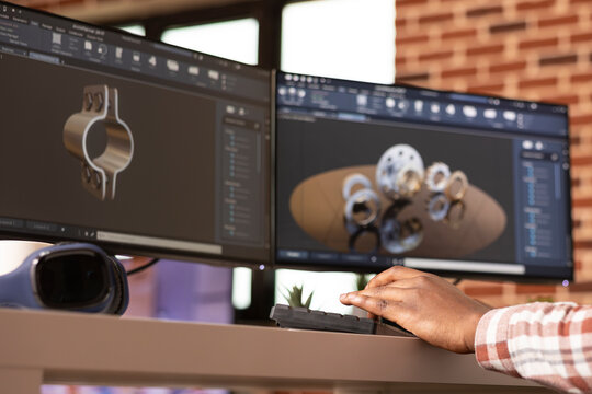 Black engineer focused on digital prototyping and 3D simulation of construction components. Remote african american cad designer analyzing project designs at desk in brick wall apartment.