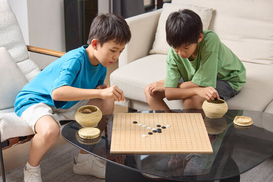 Boys focusing on the board game Go
