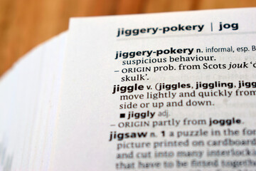 Obraz premium Close Up Of English Explanation Dictionary Page Word Of - jiggle