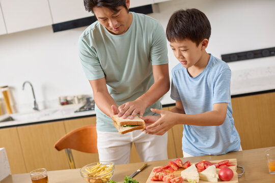 Dad walks his boy through making breakfast