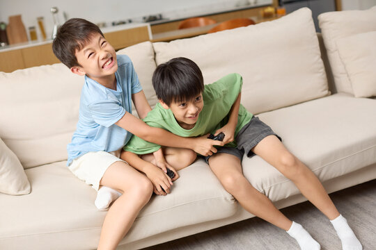 Two boys fighting over a phone to play with
