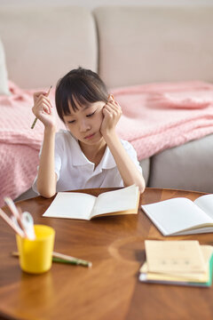A girl doing her homework at her desk
