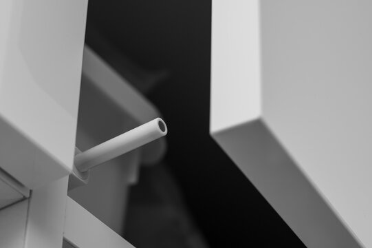 Plastic pin with a magnet in a tipon, a handleless door system in modern furniture, a close-up of the tipon in a cabinet