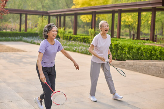 Senior women playing badminton in a park