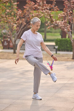 Senior woman playing shuttlecock in a park