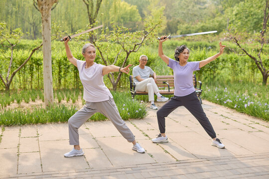 Some seniors performing a sword dance in the park
