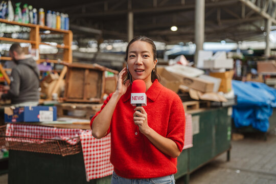 Reporter delivering a news broadcast in marketplace