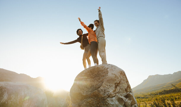 Friends celebrating on a mountain hike