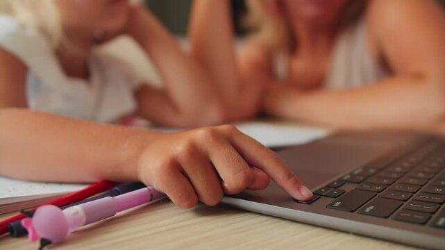 Girl studies at home with school materials and laptop, close up. Back to school concept with home technology use