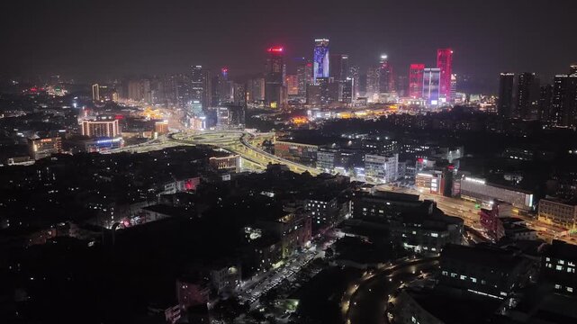Night China cityscape. Cars speed drive transport interchange. Road traffic networks. Chinese aerial drone top view fast urban circular multi-level highway. Modern city metropolis. Busy express way.
