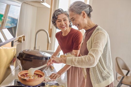 Seniors making nourishing meals at home using plenty of nutritious ingredients