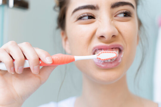 Woman brushing teeth
