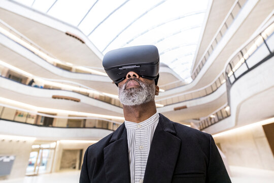 Bearded businessman using Virtual Reality Glasses