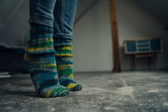Close-up uf woolen socks tiptoeing on the floor