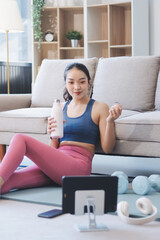 Fototapeta premium Young Asian sporty attractive people practicing yoga lesson with instructor. Asia group of women exercising healthy lifestyle in fitness studio. Sport activity, gymnastics or ballet dancing class.