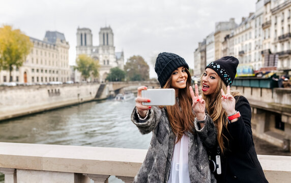 France, Paris, tourists taking selfie with cell phone