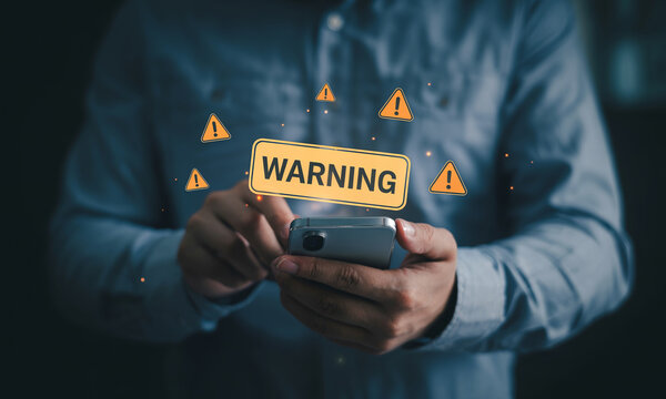 Mobile phone user receiving warning notification alerts on smartphone screen