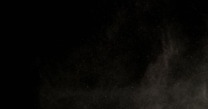 Super slow motion sandstorm and dust blizzard effect with airborne sand and fine particles, filmed at 500 fps on a high-speed camera. Isolated on black background, ideal as realistic VFX overlay.
