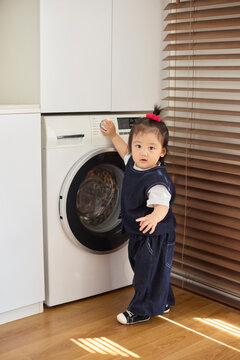 Baby girl and the washing machine