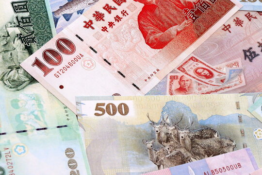 Taiwanese dollar money bills pile on table. Taiwan banknotes of TWD currency close up.