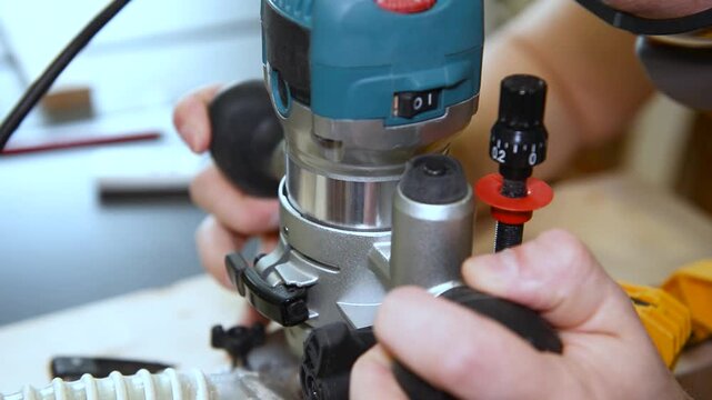 Skilled carpenter flexing his muscles while using router at construction site. Wood router in action smoothly cutting into a wooden surface. shot highlights woodworking craftsmanship