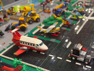 Naklejka premium Toy brick airport runway with jet and service vehicles