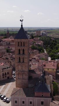 Vertical aerial view of Iglesia de San Esteban showcasing its tall Romanesque tower and surrounding old town architecture.