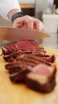 Vertical Close Up Hands Slicing Grilled Red Meat With Knife, Barbecue Steak Cutting