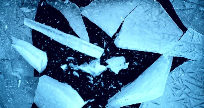 Ice explosion and shattering impact, frozen blocks breaking apart and scattering in air. Super slow motion, 1000 fps. isolated on black background. Dramatic freeze burst effect.