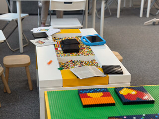 Naklejka premium Children's mosaic play table with lego and craft supplies