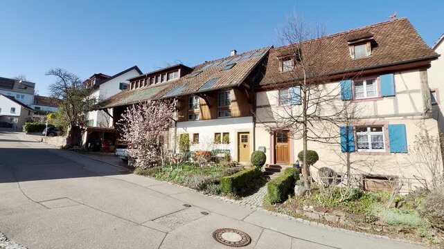 Old half-timbered houses in L&ouml;rrach, Germany, a tree is blossoming, panning shot