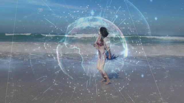Model taking tech cue, dancing to sea, twirling then running into waves while hologram over model