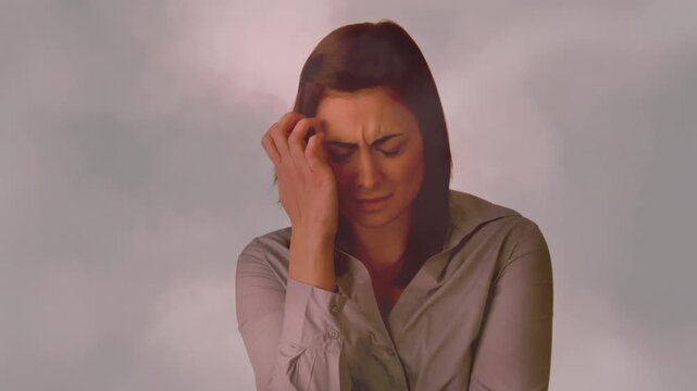 Woman reacting to bad headache raising hand to temple health overlay pulsing around head for relief