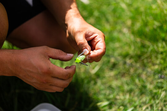 Man getting fly bait ready for fishing day in summer
