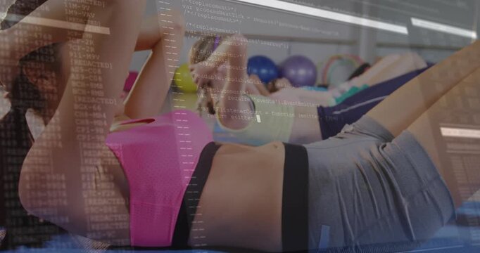 Class start lead woman doing crunches, others mirroring, building core, code overlay appearing