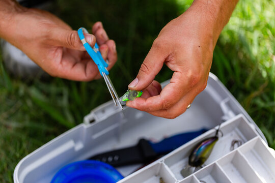 Man getting fly bait ready for fishing day in summer