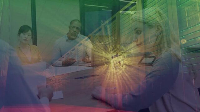 Man presenting papers and causing starburst overlay over front woman and table in office meeting