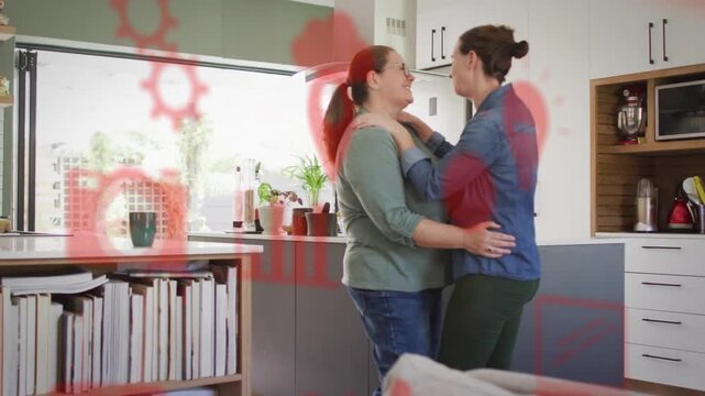 Vertical video: Couple locking eyes, holding in kitchen loving red tech overlay animating over them