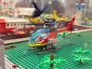 Naklejka premium Red lego helicopter on green baseplate