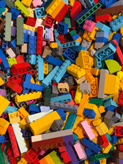 Naklejka premium Colorful plastic construction bricks pile