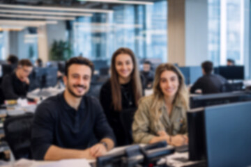 Fototapeta premium Blurred Diverse office team smiling at camera, modern workplace, collaboration, business people