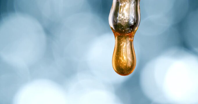 Slow Motion Macro Of Luxury Serum Drop Falling And Splashing In Close Up Concept Of Skincare And Beauty
