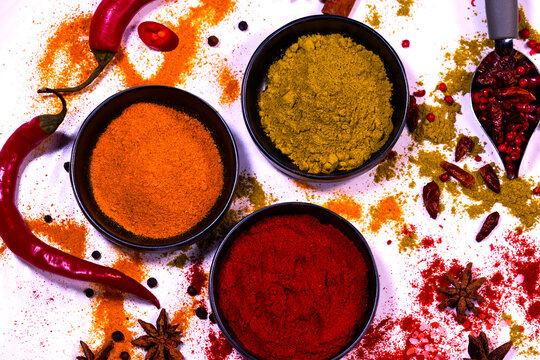 Natura morta. Still life con spezie colorate in polvere e semi su piatto bianco.	