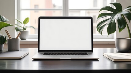 Fototapeta premium Modern workspace featuring laptop computer on desk with plants and natural light